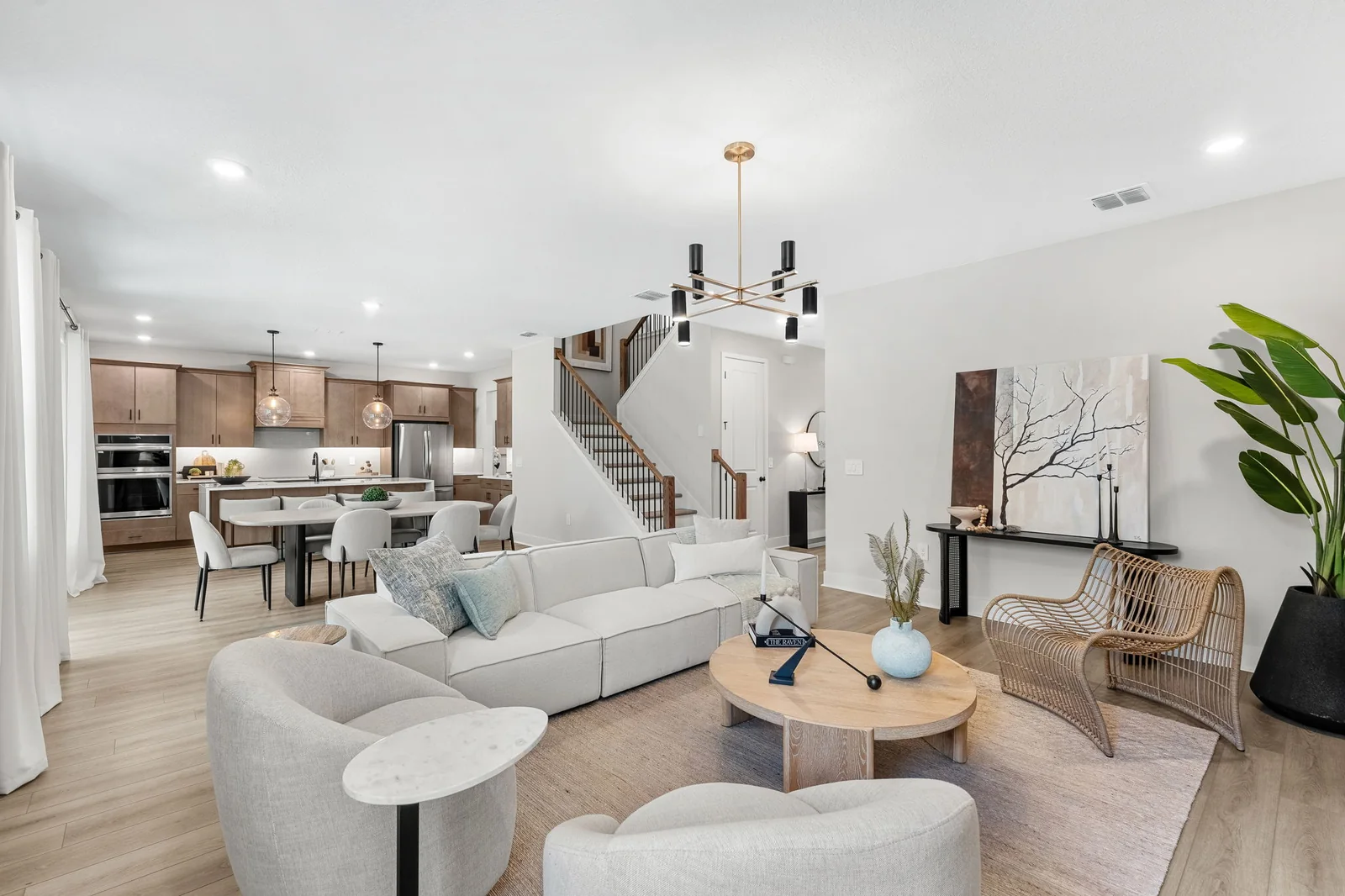 A staged open living and dining space with natural textures
